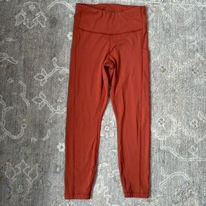 Athleta ultimate capri stash pocket 7/8 burnt orange color